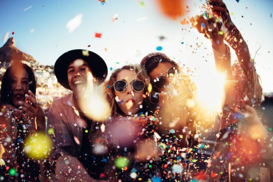 Teenager-hipster-friends-partying-by-blowing-colorful-confetti-from-hands-513550806_8660x5773.jpeg